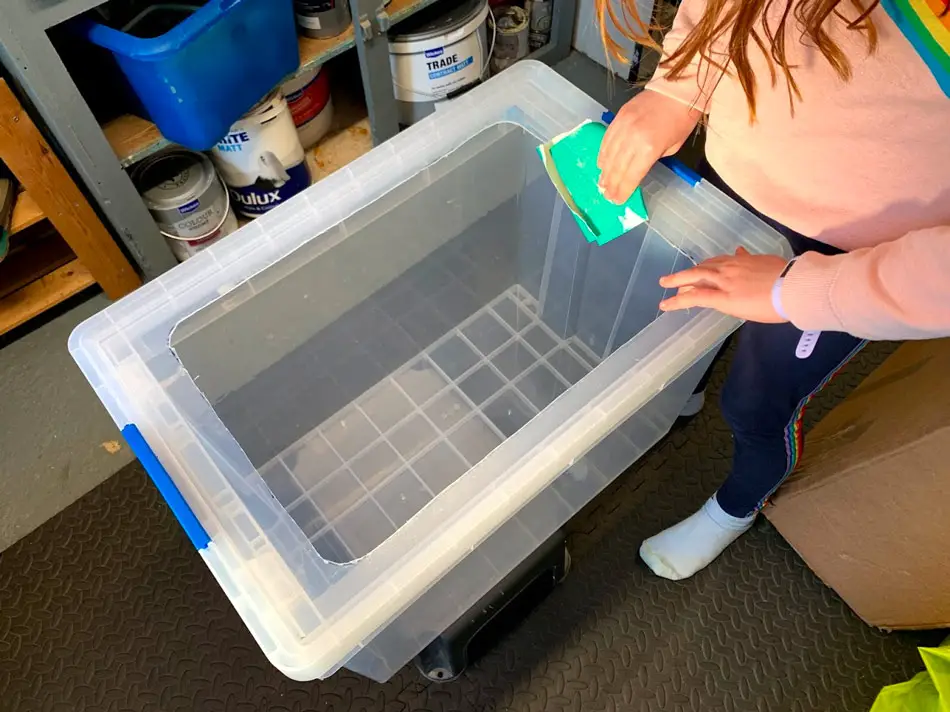 sanding down any sharp edges on the bin